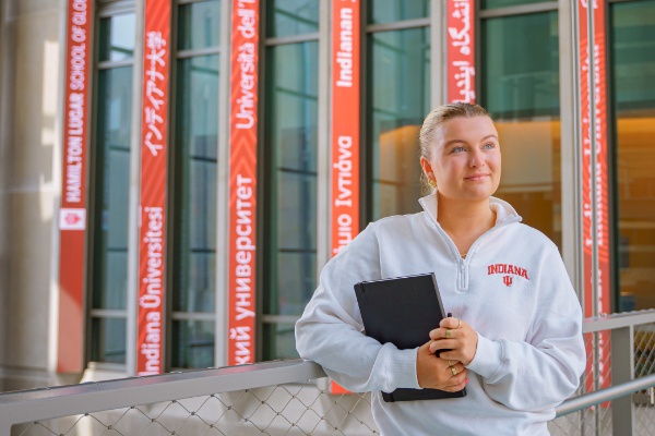 Student drops research sample into tube.